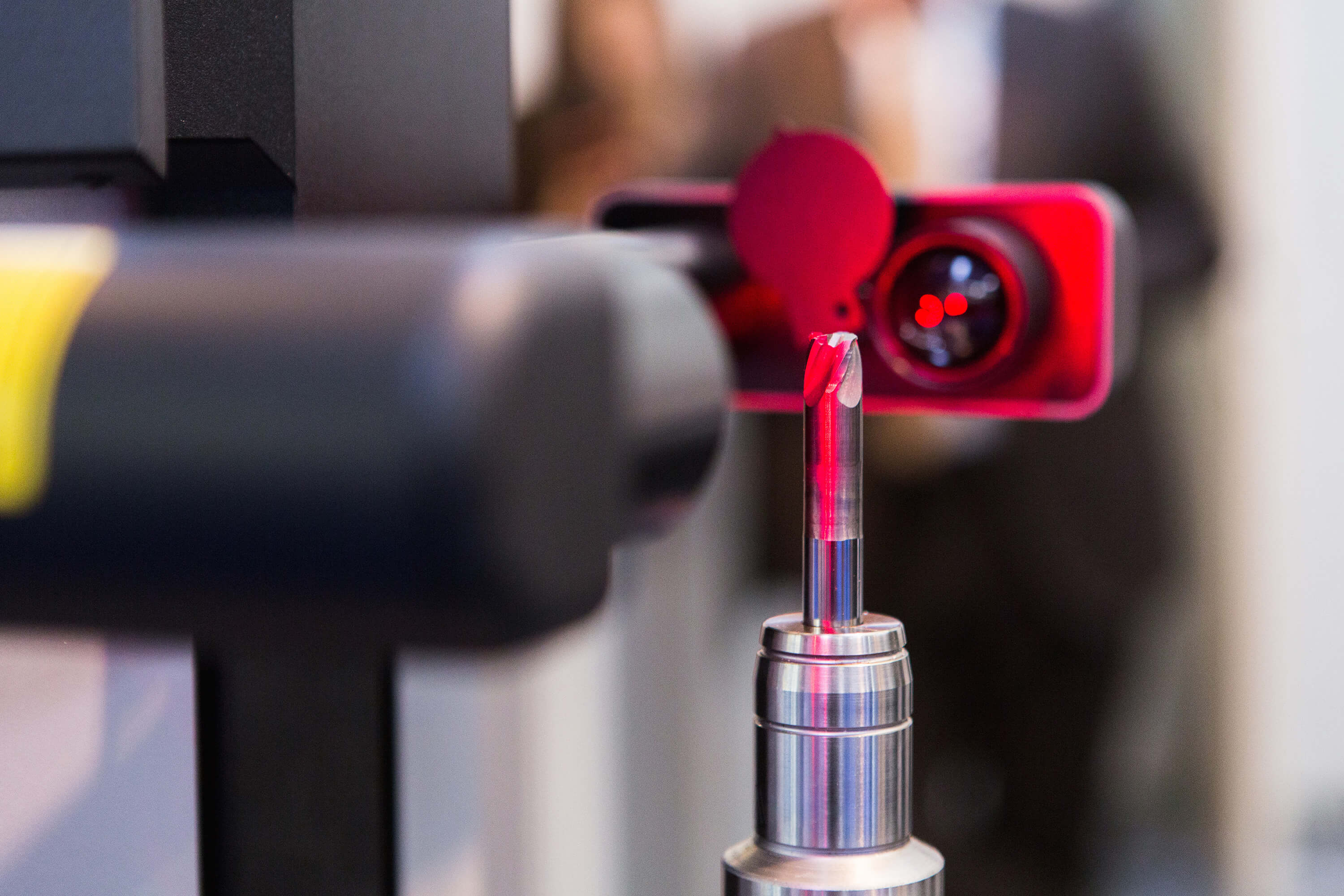 A robot arm performing a laser-enabled part inspection